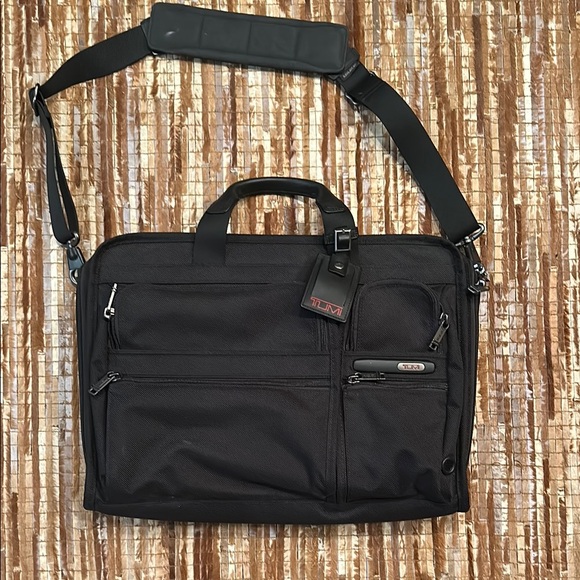 Tumi Black Briefcase with Detachable Shoulder Strap and Durable Fabric